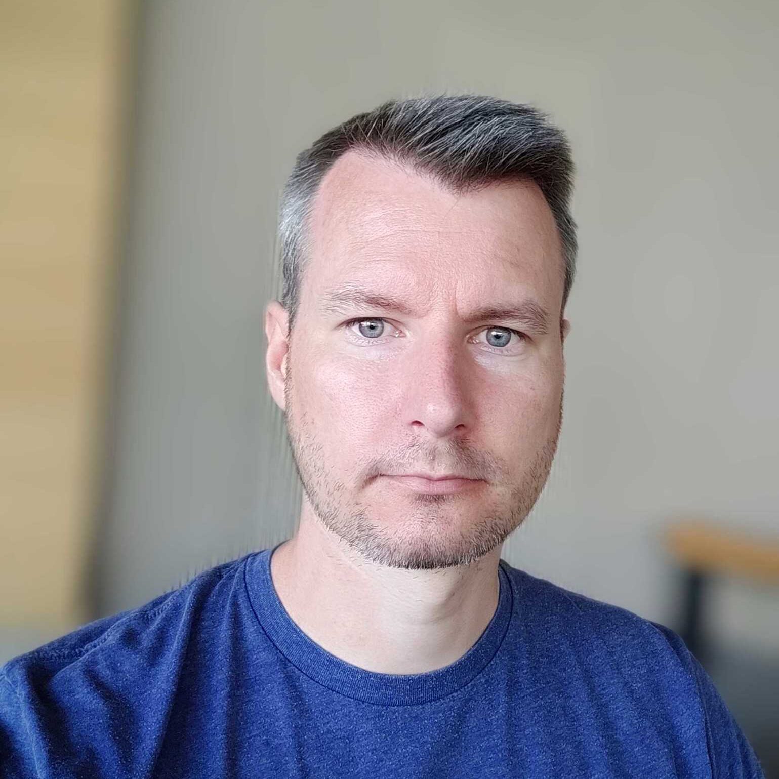Become a member of Mautic 3 Photo of a white man with short dark hair wearing a blue Mautic tshirt.