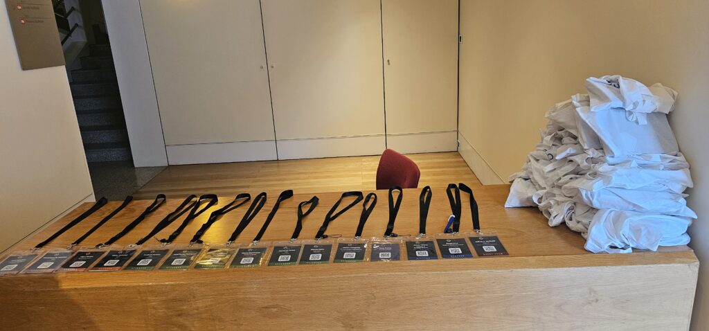 What's new in Mautic? Learnings from Mautic Conference Europe 1 Photo of lanyards laid out on a bench with swag bags piled alongside.