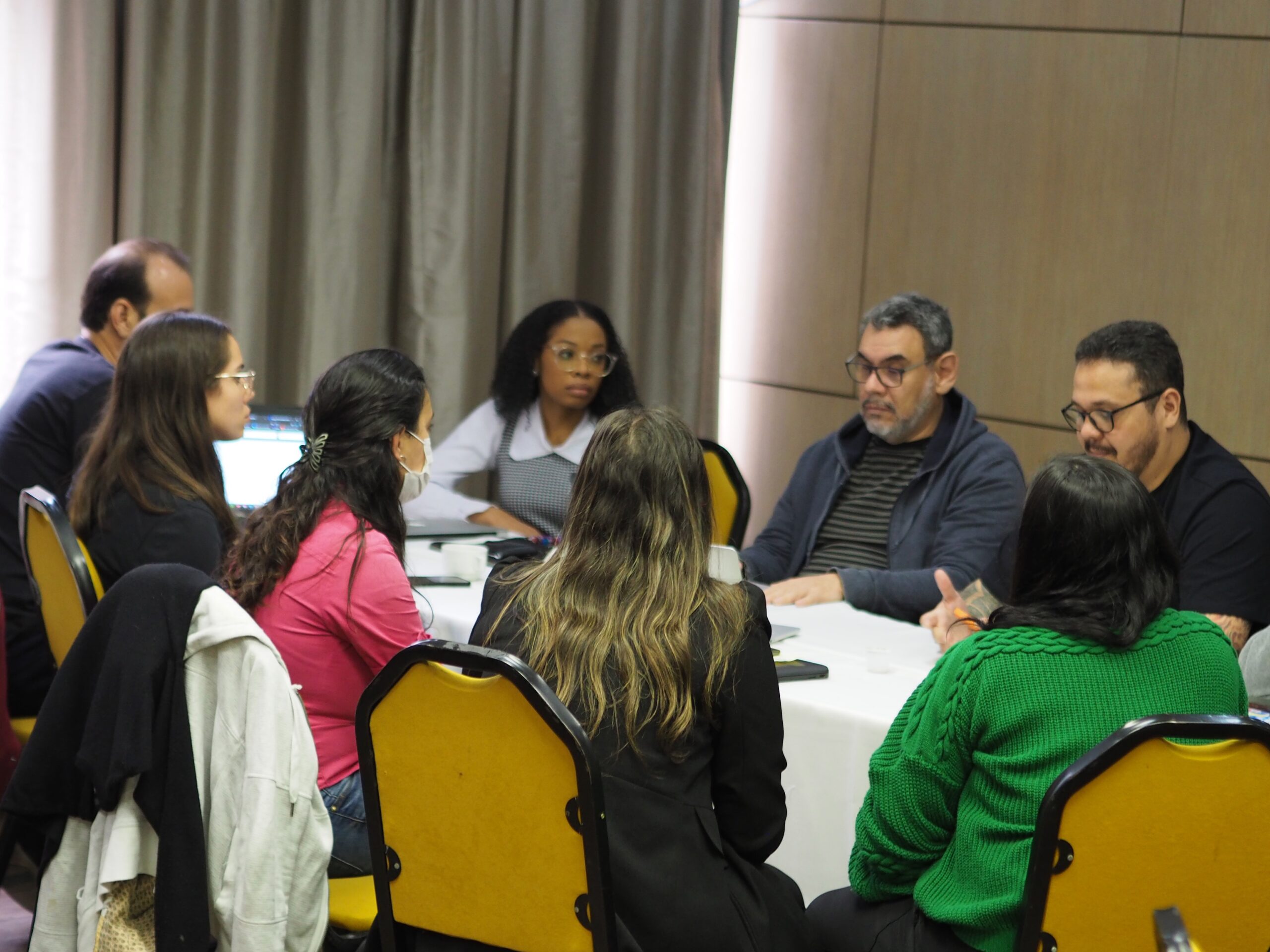 Contribute to Mautic 2 Photo of a diverse group of people sitting around a table collaborating on a project.