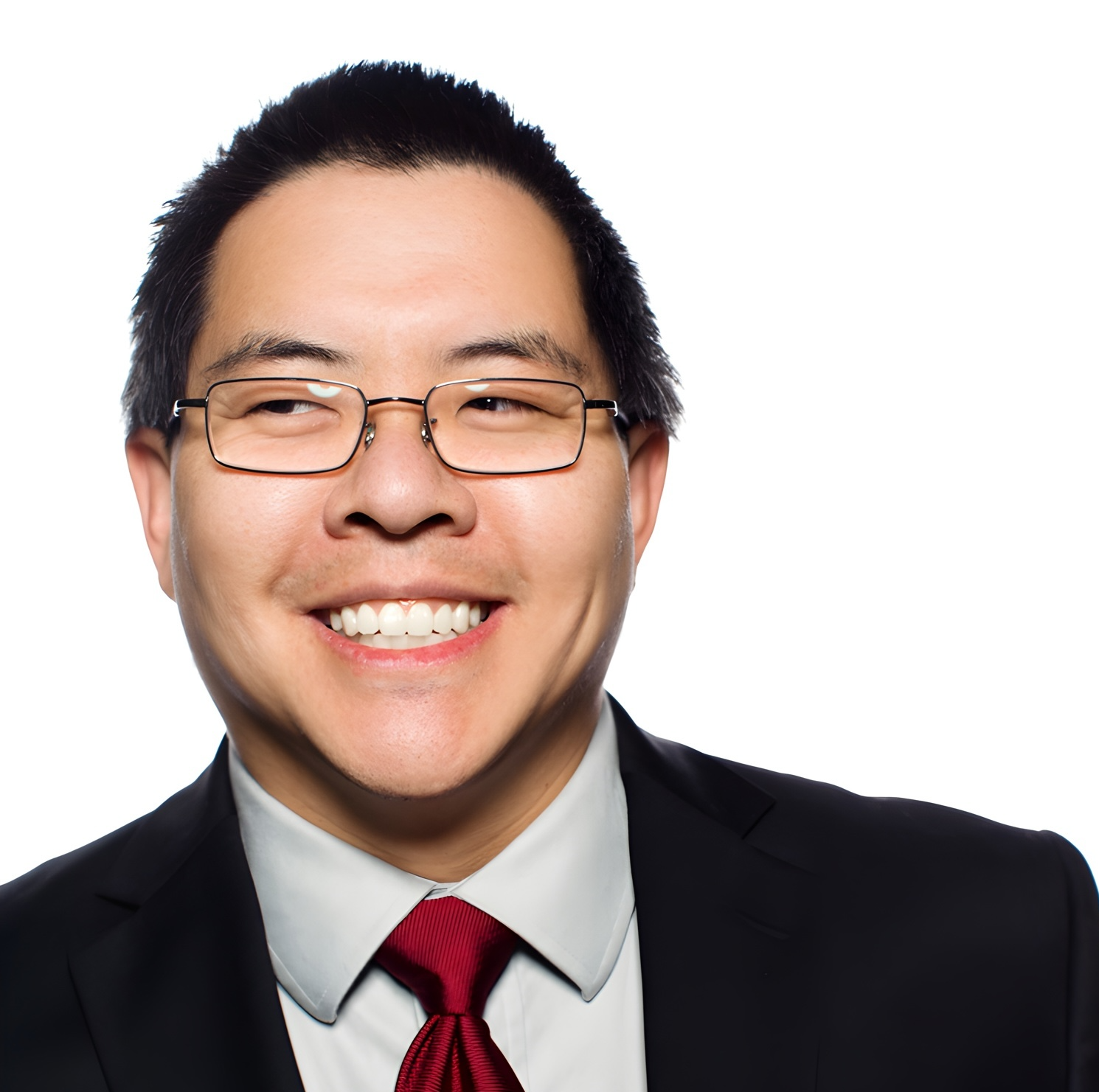 Mautic use by verticals 14 Photo of an asian man wearing glasses with short dark hair. He's wearing a dark black suit with a pale collared shirt and a red tie.